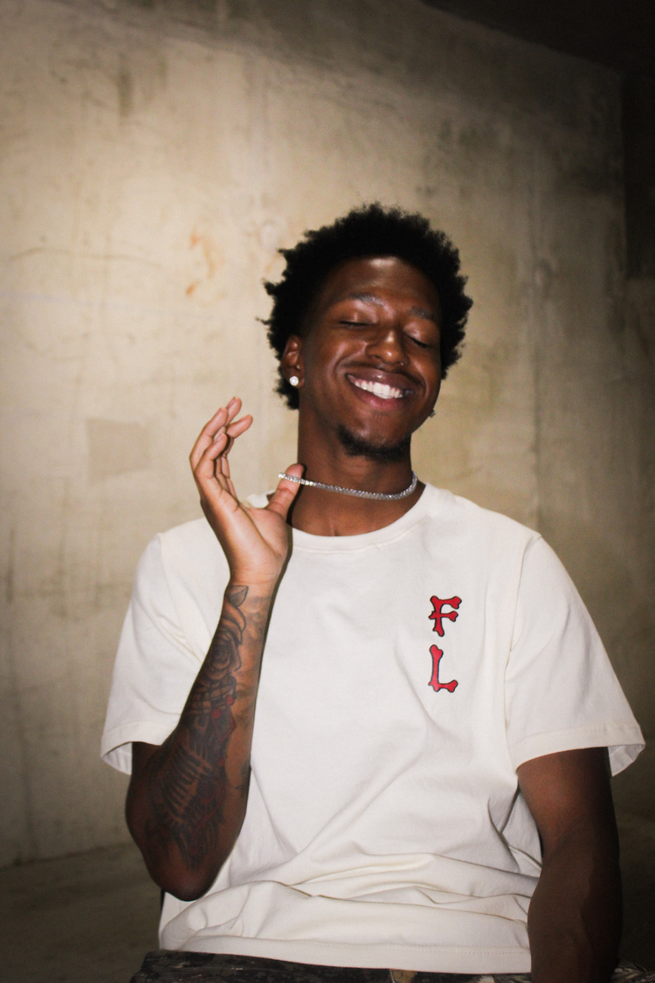 Model laughing in the crème F8VR tee with red FL chest print